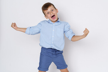 The boy expresses emotions by shouting and spreading his arms in different directions. Isolated on white background.
