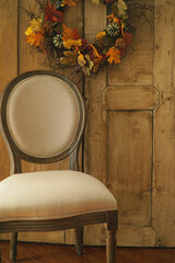 Fototapeta na wymiar Designer chair with wreath on door