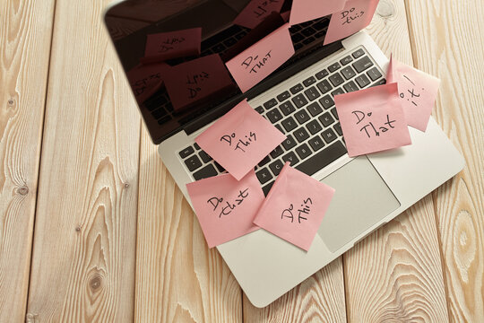 Image of laptop full of sticky notes reminders on screen. Work overload concept image. Coworking or working at home concept image.