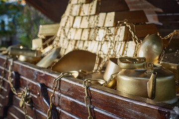 Open treausre chest of gold. Gold teapot, gold bars and gold chains