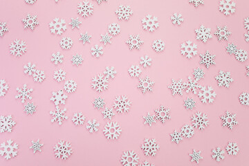 Snow flakes pattern on pink background. Top view