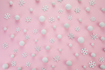 Christmas minimal concept. Snowballs and snowflakes on pink background.