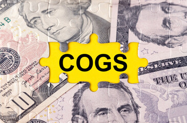Puzzle with the image of dollars in the center of the inscription -COGS