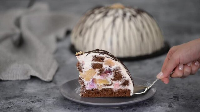 Piece of Pancho cake with pineapple and sour cream topped with chocolate and nuts.