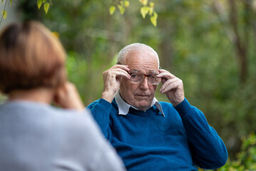 Old couple talking in park