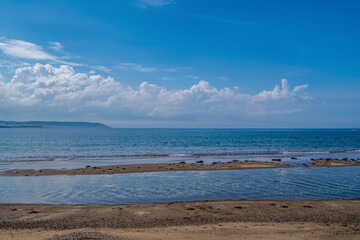 Sandy beach with sandbanks, sunny day. Devon, UK. Ideal coast background.