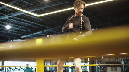 Sporty fit man training techniques in sport club. Sport man exercising at gym