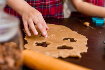 Two little girls cook at home in the kitchen ginger cookies for Christmas