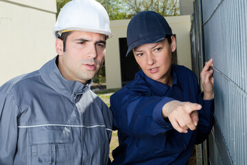 female builder pointing at something outdoors