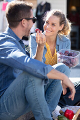 smiling young woman feeding her loving man