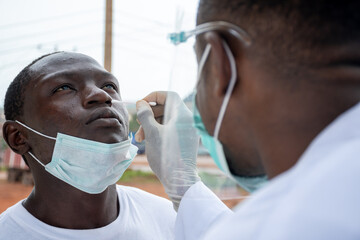 lab scientist taking nasal sample from a man