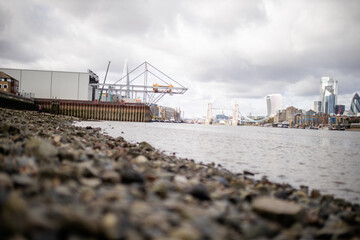 Landscape View of a Cityscape from the Rocky Ground Alongside the River Thames