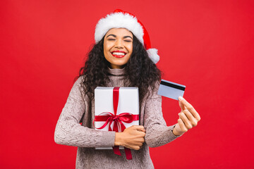 Beautiful portrait of young african american woman happy holding credit card and gift box in...