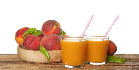 Natural freshly made peach juice on wooden table, white background