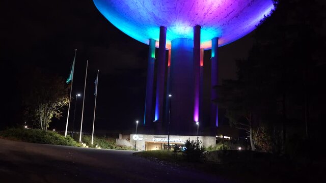 Espoo, Finland - October 20, 2020: Colorful light show on old water tower at Haukilahti, that is transformed to be used as restaurant