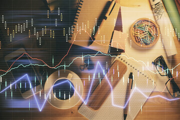 Double exposure of forex graph drawing and work table top veiw. Concept of financial analysis.