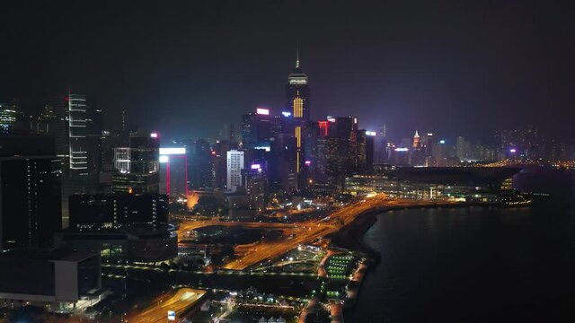 night time illuminated hong kong city downtown traffic bay aerial panorama 4k
