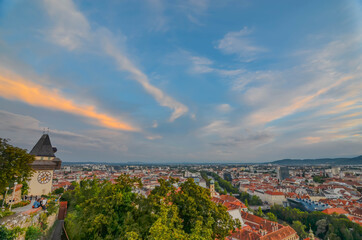 Graz, Austria- August 30, 2020: Cityscape of Graz and the famous clock tower on Schlossberg hill, Graz, Styria region, Austria, at sunset