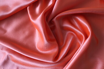 Obraz premium Smooth elegant coral silk or satin fabric. Draped luxury cloth texture for design. Close-up