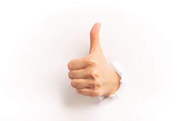 Thumps up gesture stick out of white paper on white