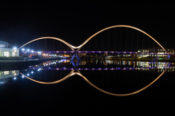 The famous Infinity Bridge perfectly reflected in a glass like River Tees on cold crisp winters night