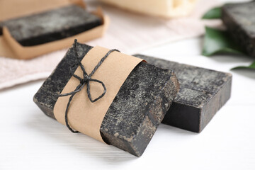 Natural tar soap on white table, closeup
