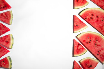 Slices of ripe watermelon on white background, flat lay. Space for text