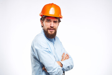Cheerful man orange hard hat work industry professional lifestyle light background