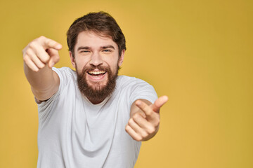 Fototapeta premium Bearded man in white t-shirt emotions close-up fun yellow background