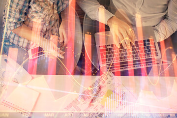 Multi exposure of man and woman working together and forex graph hologram drawing. Financial analysis concept. Computer background. Top View.