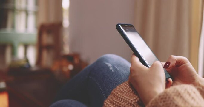 Woman Using Smartphone Stay at Cozy Home. SLOW MOTION. Unrecognizable female hands with cell phone, texting, serching internet, social network, reading, learning. Technology in everyday lockdown life.