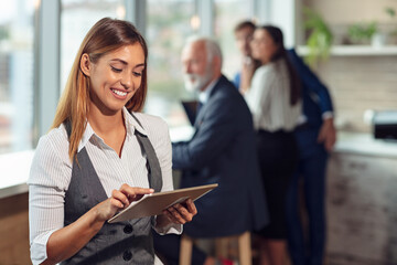 Business woman holding files. Looking at files.