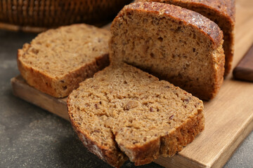 Tasty freshly baked bread on grey table, closeup