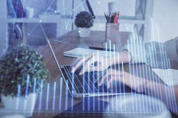 Double exposure of woman hands typing on computer and forex chart hologram drawing. Stock market invest concept.