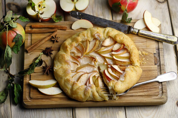 Apple biscuit on a wooden board. Galette. Homemade baking. Desserts with apples.