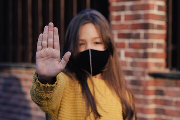 Kids trick or treat in Halloween costume and face mask. Coronavirus Halloween. Child celebrates holiday in quarantine.