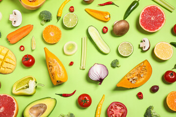 Flat lay composition with fresh organic fruits and vegetables on light green background
