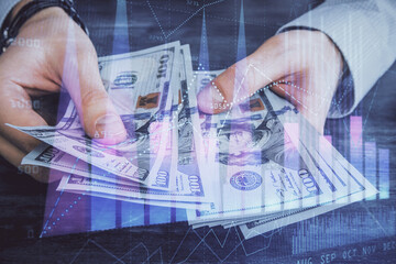 Multi exposure of financial graph drawing hologram and USA dollars bills and man hands. Analysis concept.