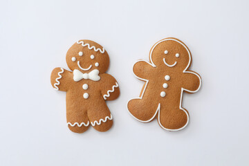 Christmas human shaped gingerbread cookies on white background, top view
