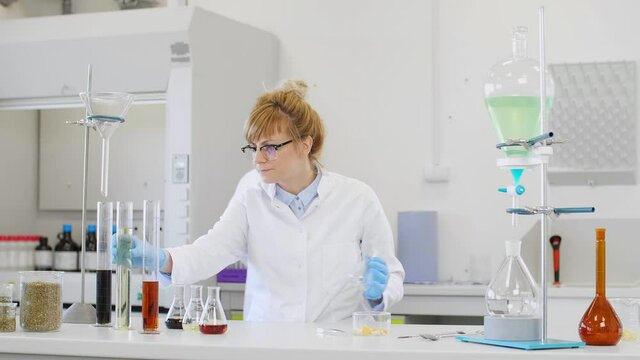 Chemist working with hemp CBD oil and tablet in laboratory