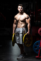 Fototapeta na wymiar Bodybuilder Holding Weights In Hand