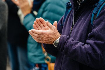 Senior man hand clapping at the Place Kleber to pay tribute to history teacher Samuel Paty,...