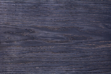 The texture of a wooden board painted in purple. Empty background.