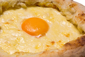 Adjarian Khachapuri closeup. Georgian national food. Focus on the yolk