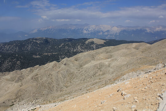 Summit of Tahtali Dag (Olympos Mountain), 2365 m MSL with steep slope visible on foreground and turkish Taurus Mountains range in the background, Kemer, Antalya Region
