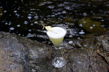 cocktail on rocks in river