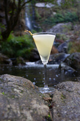 cocktail on rocks in river