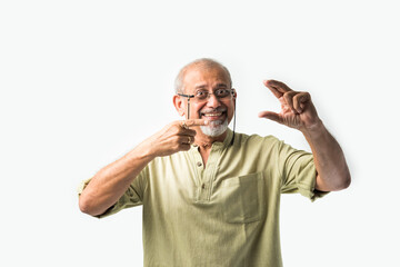 Indian asian senior adult male or old man presenting something