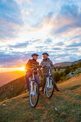 Obraz na płótnie Canvas Active Senior Couple Riding Bikes In Park