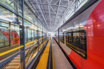 Fototapeta premium Passenger train stands by the platform before departure.